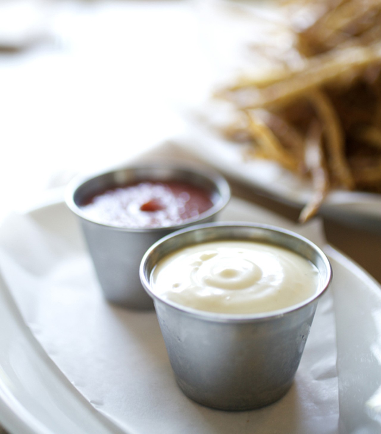 The duck fat frites are served with house made ketchp and mayonnaise.