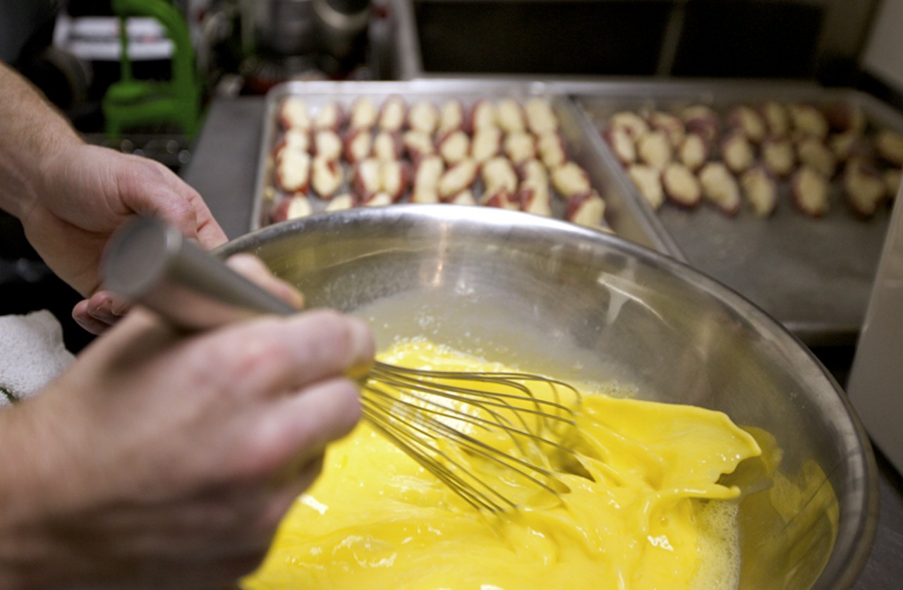 Beating the egg wash for the Papas Rellenas, which are balls of mashed Yukon potatoes filled with picadillo and Spanish cheese; flash fried and served with warm sofrito for dipping.